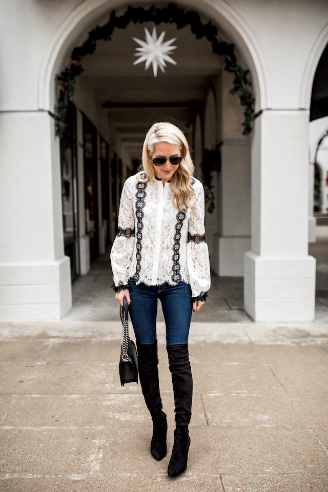 White lace blouse by Alexis with bell sleeves and black trim